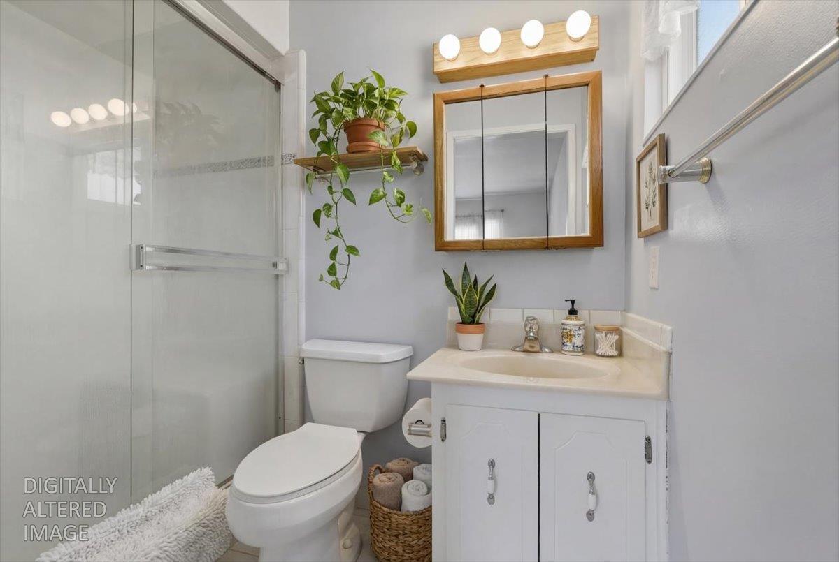 2807 Layton Drive Davis, CA 95618 - Photo 13 of 23 a bathroom with a granite countertop sink toilet and mirror