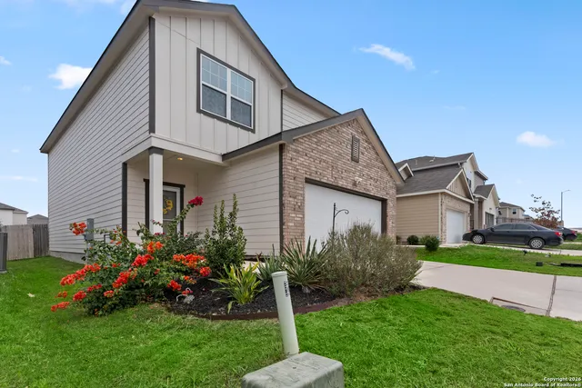 a front view of house with a garden