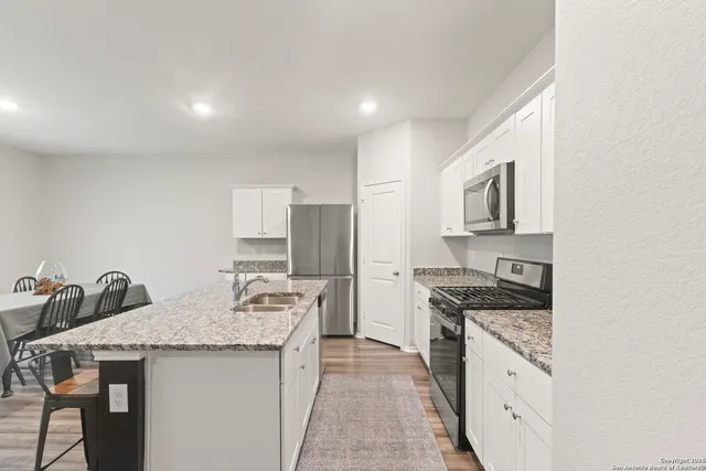 a kitchen that has a sink and a stove