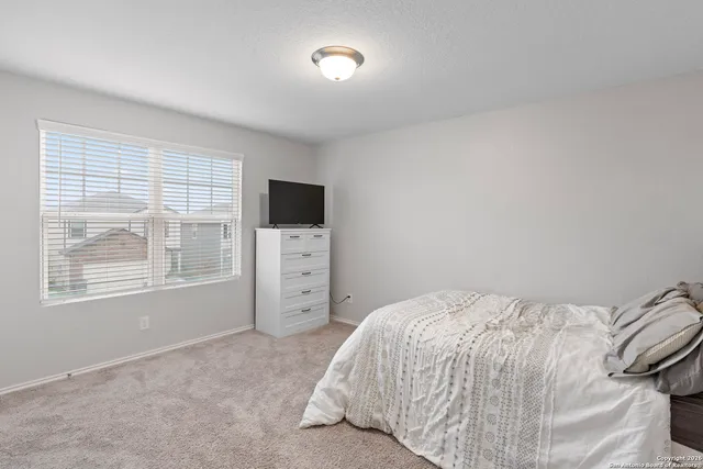 a bedroom with a bed and a television