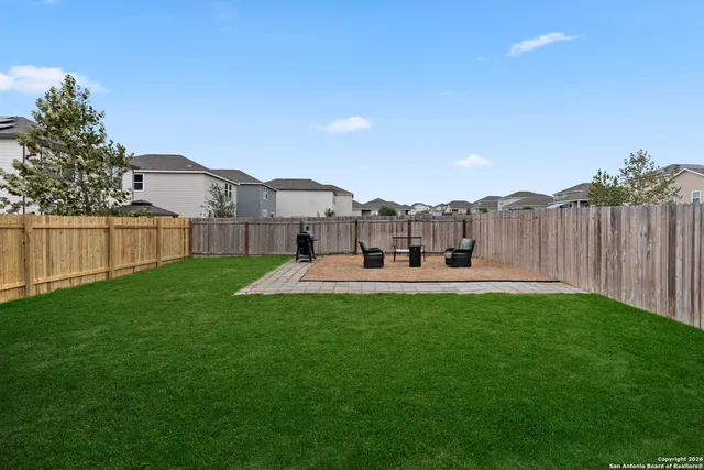 a view of a house with backyard porch and sitting area