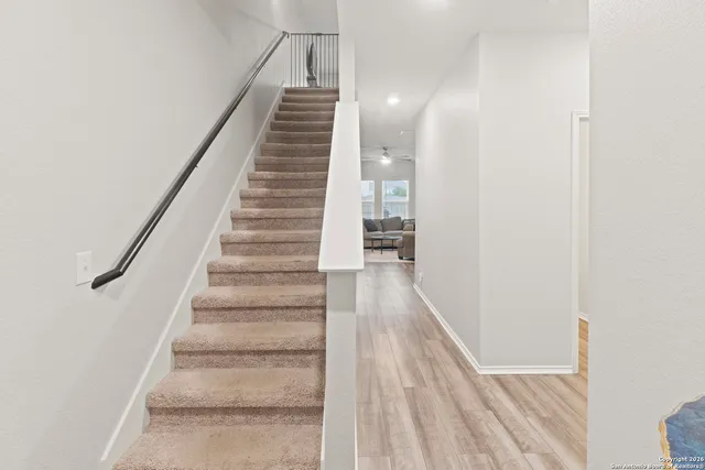 a view of entryway and gallery with wooden floor
