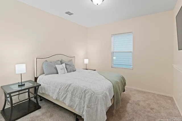 a bedroom with a bed and a night stand