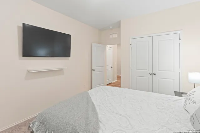 a bedroom with a bed and a flat screen tv