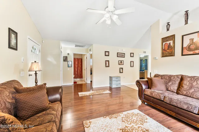 a living room with furniture and wooden floor