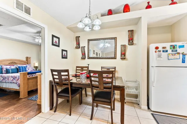 a view of a dining room with furniture and chandelier