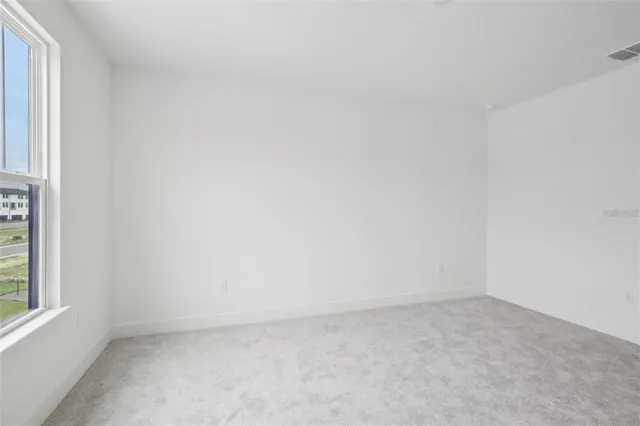 a view of an empty room and a window