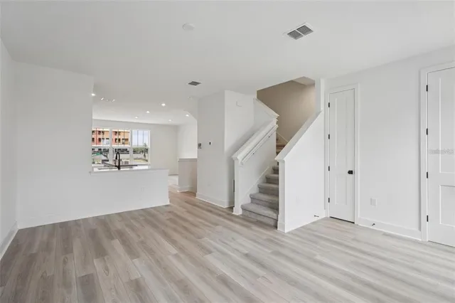 a view of a room with wooden floor and stairs