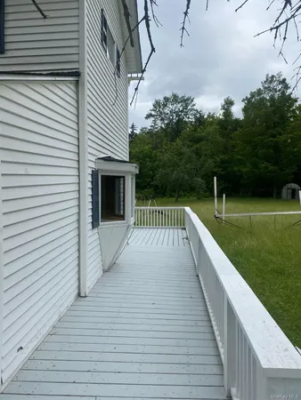 a view of a balcony with yard