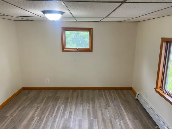 a view of a room with wooden floor and a window