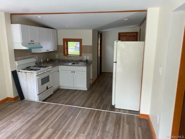 a kitchen with a sink a refrigerator and a stove