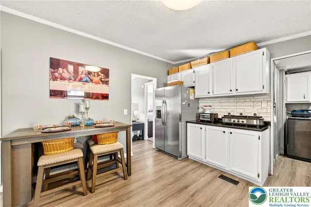 a kitchen with stainless steel appliances a stove a sink and a refrigerator