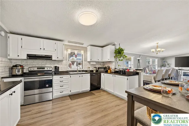 a kitchen with a stove cabinets and wooden floor