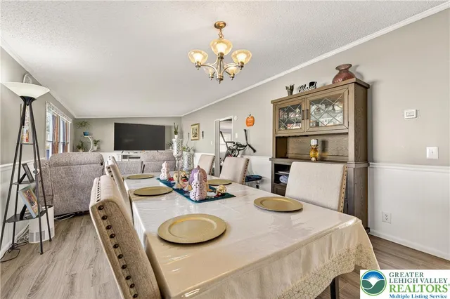 a dining room with furniture and a chandelier