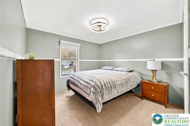 a bedroom with a bed and a lamp