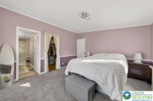 a spacious bedroom with a bed and a dresser