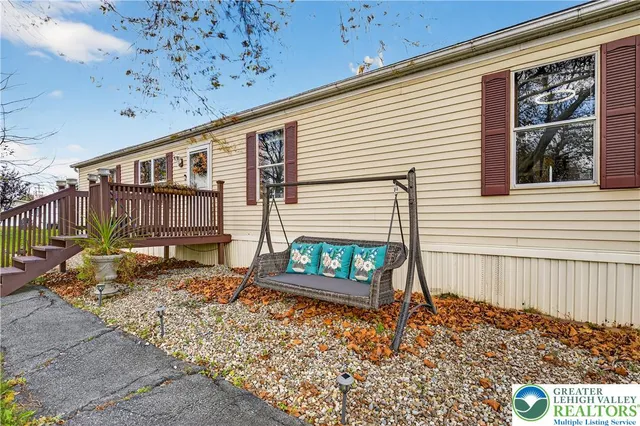 a view of a house with a small window and wooden fence