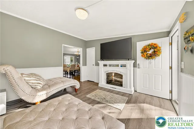 a living room with furniture a fireplace and a flat screen tv