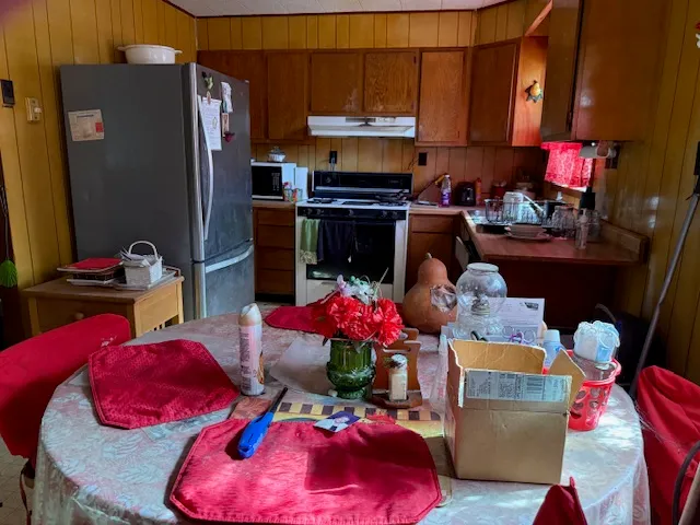 a living room with furniture a window and a flat screen tv
