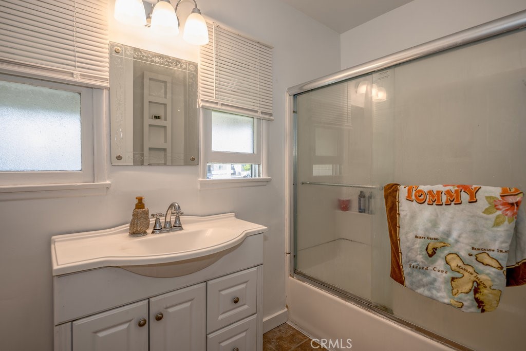 17654 Welby Way Van Nuys, CA 91406 - Photo 14 of 26 a bathroom with a sink and a mirror
