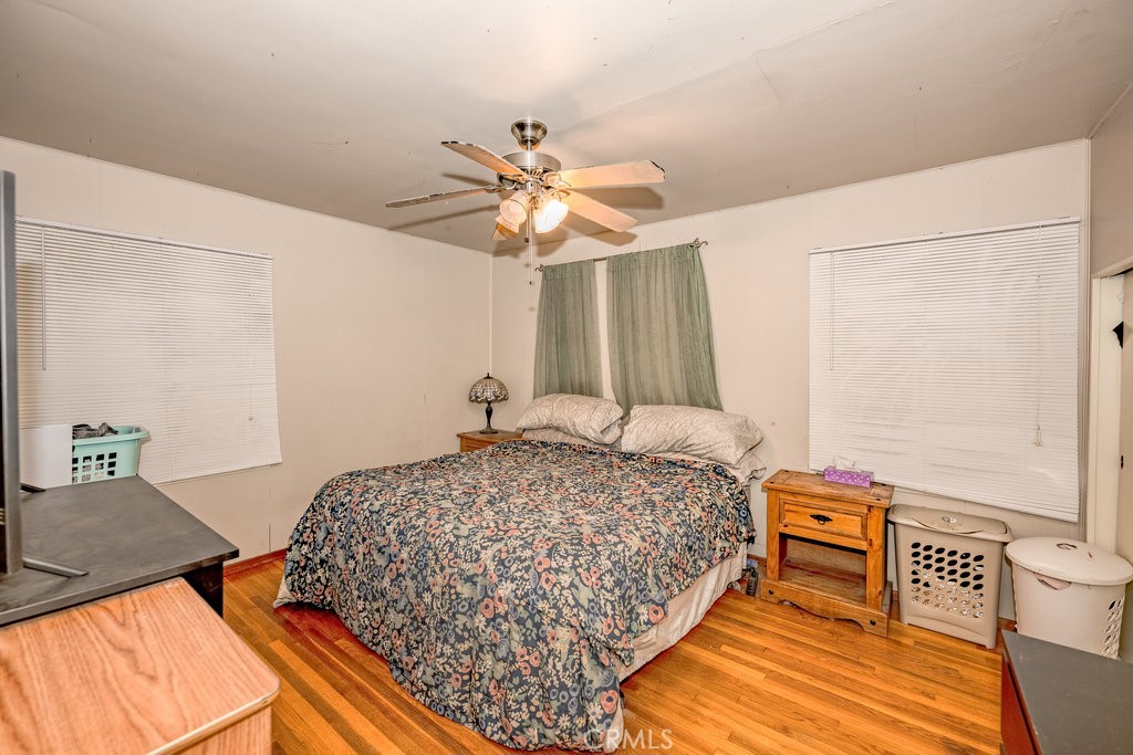 17654 Welby Way Van Nuys, CA 91406 - Photo 15 of 26 a bedroom with a bed and a chandelier