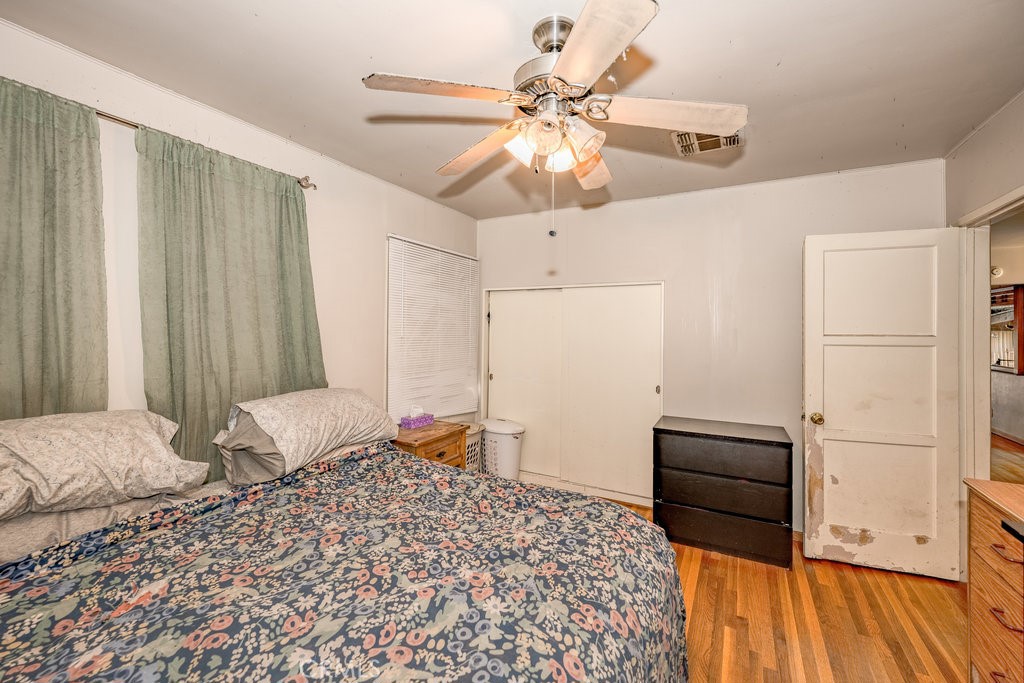 17654 Welby Way Van Nuys, CA 91406 - Photo 16 of 26 a bedroom with a bed and a chandelier