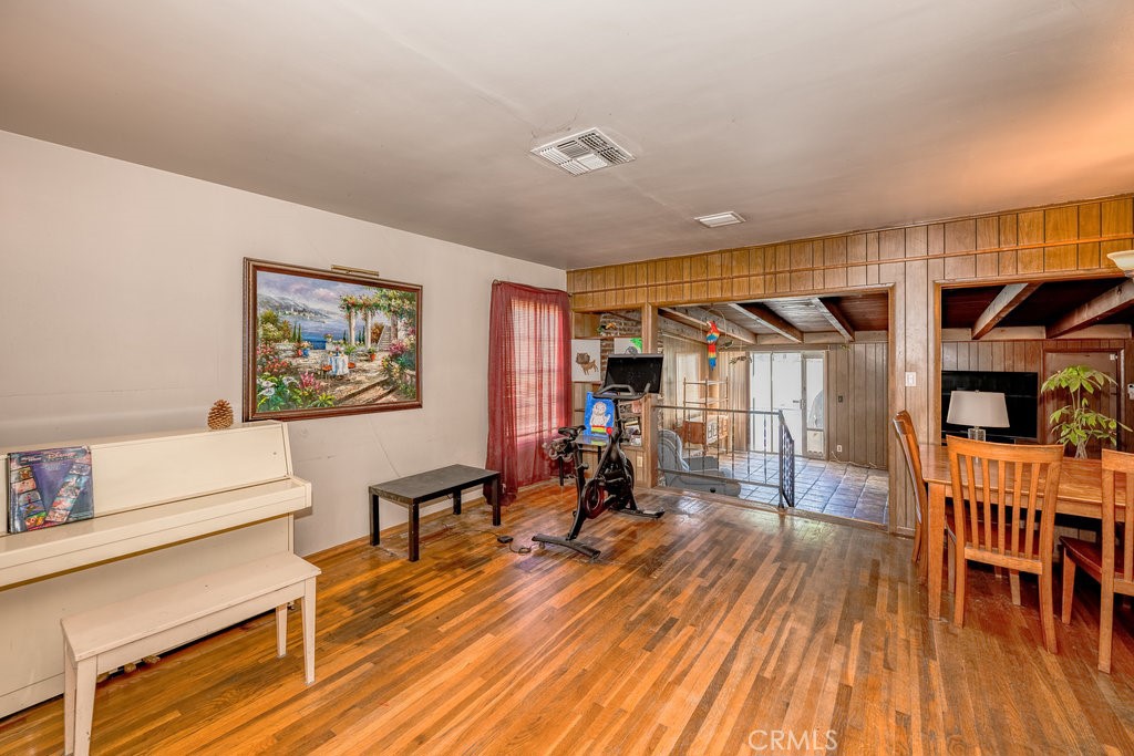 17654 Welby Way Van Nuys, CA 91406 - Photo 9 of 26 a living room with furniture and a wooden floor