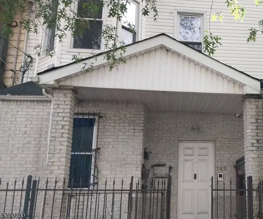 a close view of a brick house with a small yard and large window