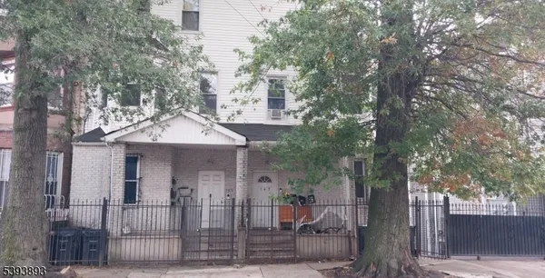 a front view of a house with tree s