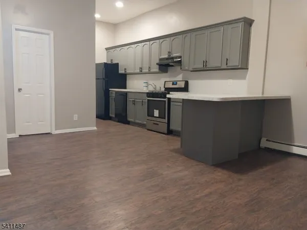 a kitchen with stainless steel appliances a refrigerator and a stove top oven