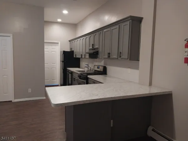 a kitchen with kitchen island a sink stove and refrigerator