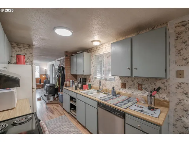 a kitchen with a sink a stove and cabinets