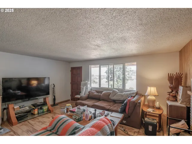 a bedroom with furniture and a flat screen tv