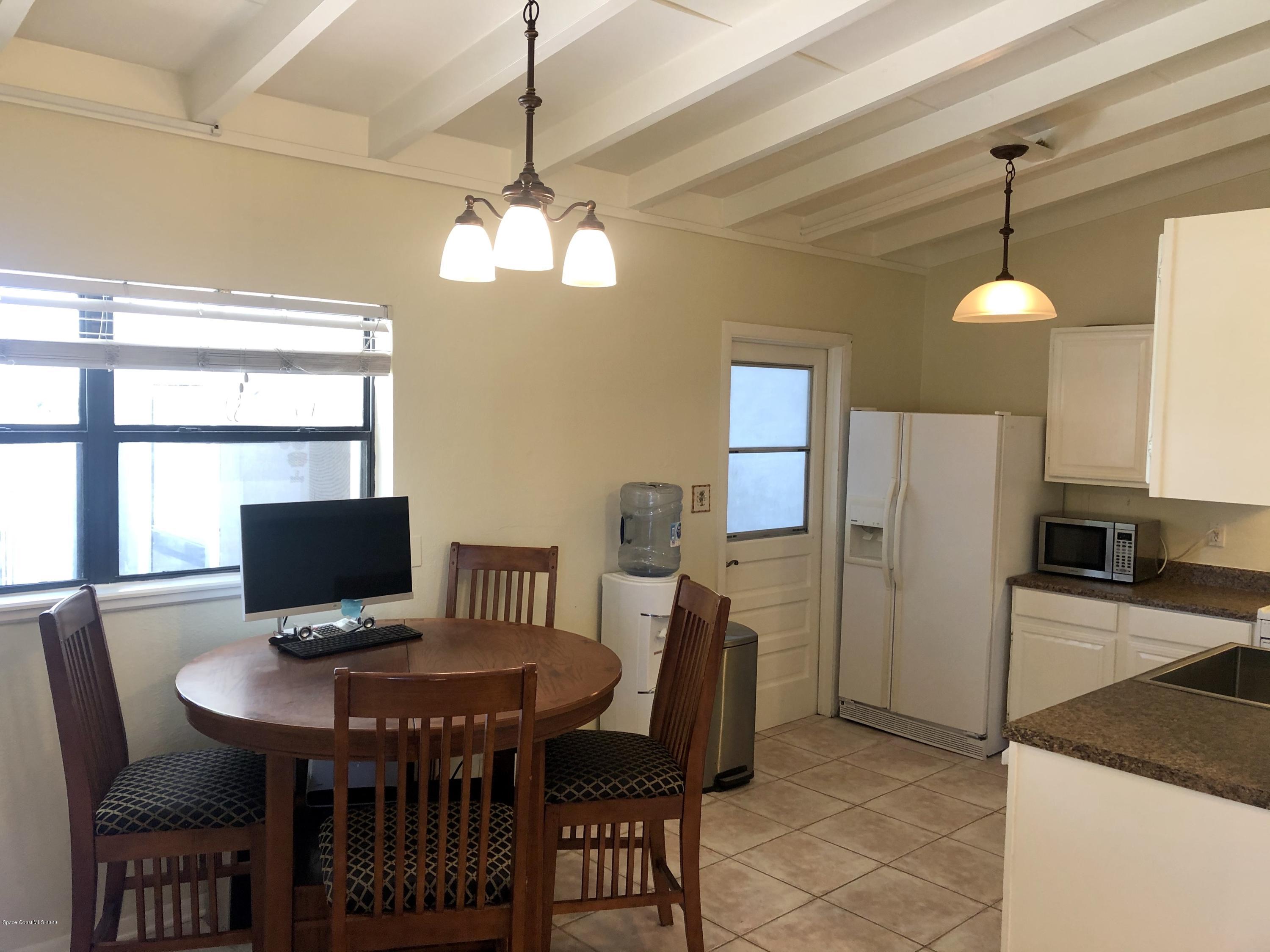2224 Laden Road Melbourne, FL 32935 - Photo 3 of 26 a view of a dining room with furniture a chandelier and window
