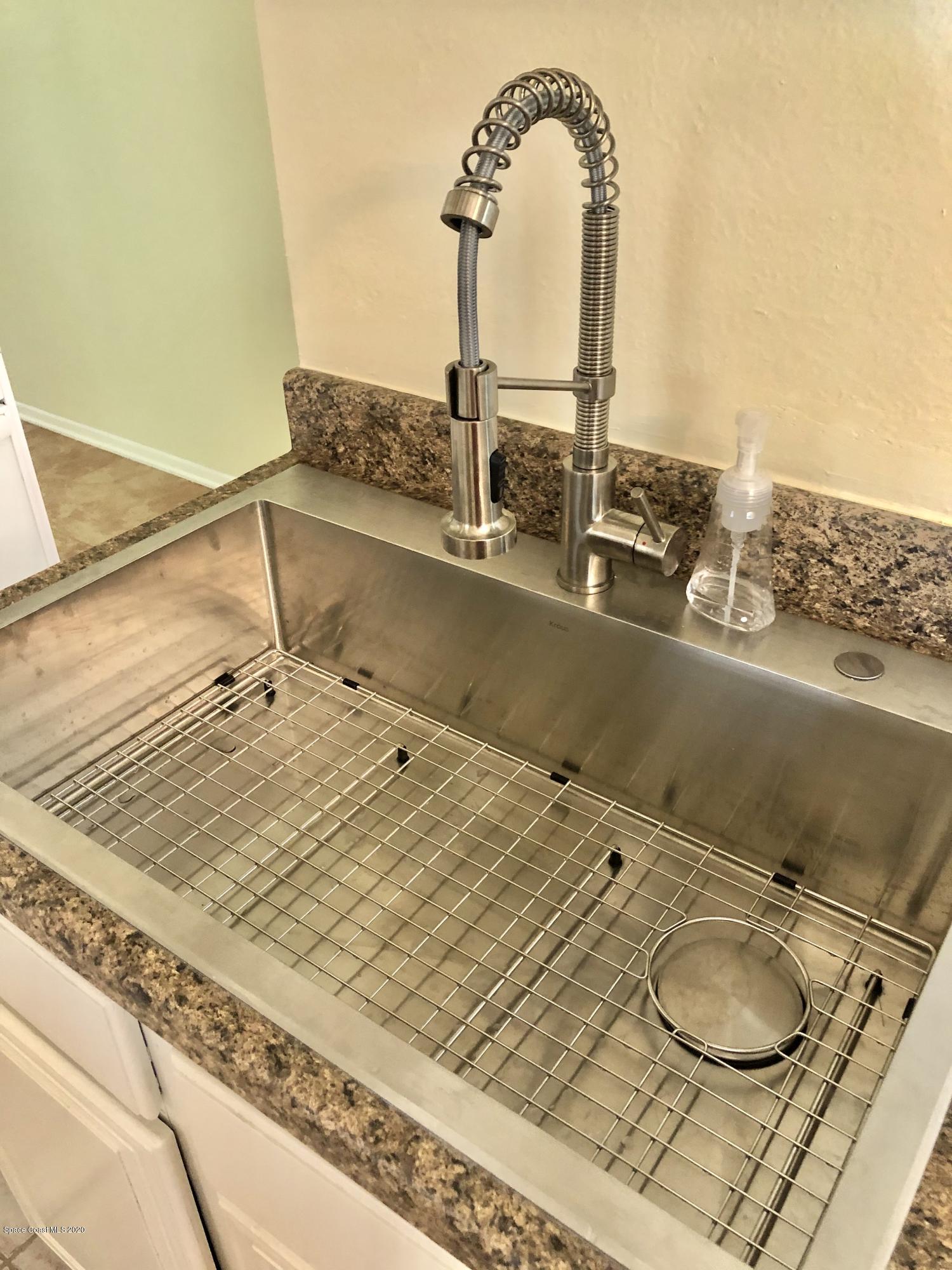 2224 Laden Road Melbourne, FL 32935 - Photo 6 of 26 a room with a table and chairs