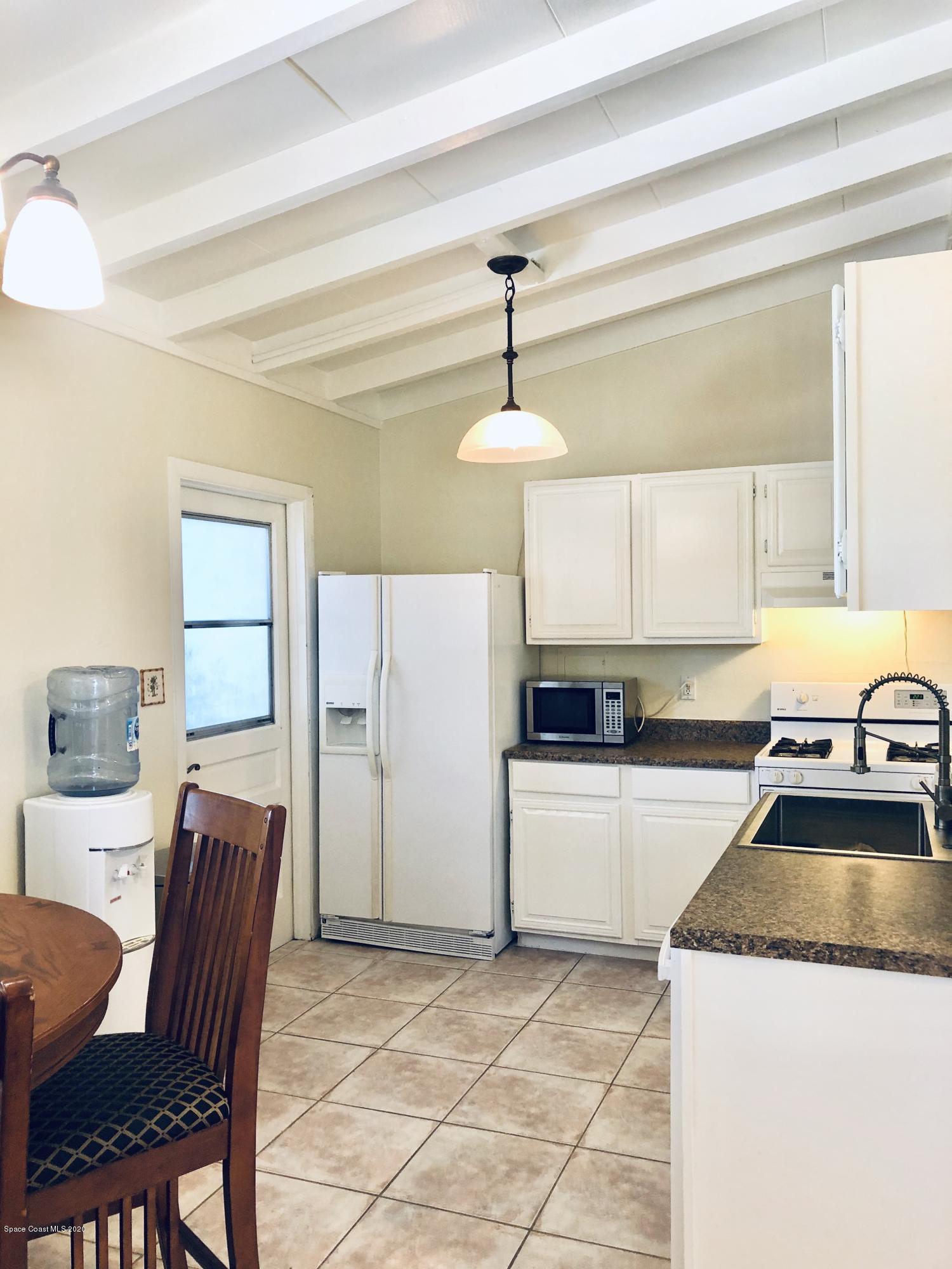 2224 Laden Road Melbourne, FL 32935 - Photo 7 of 26 a kitchen with stainless steel appliances granite countertop a sink and a refrigerator