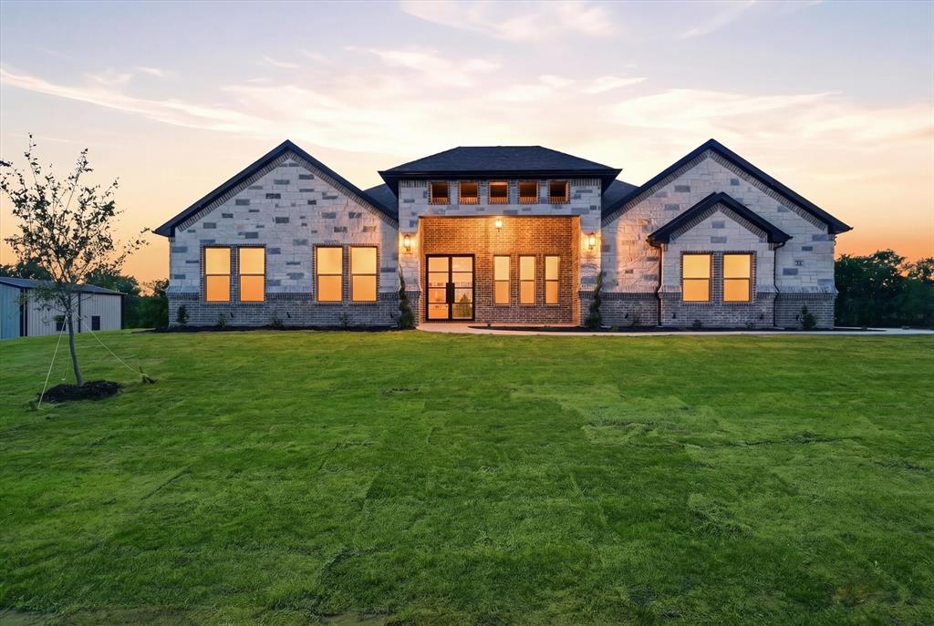 182 Briar Patch Azle, TX 76020 - Photo 1 of 36 Back of house at dusk with a yard, brick siding, and stone siding