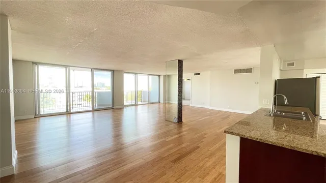 a view of a kitchen island wooden floor and a window