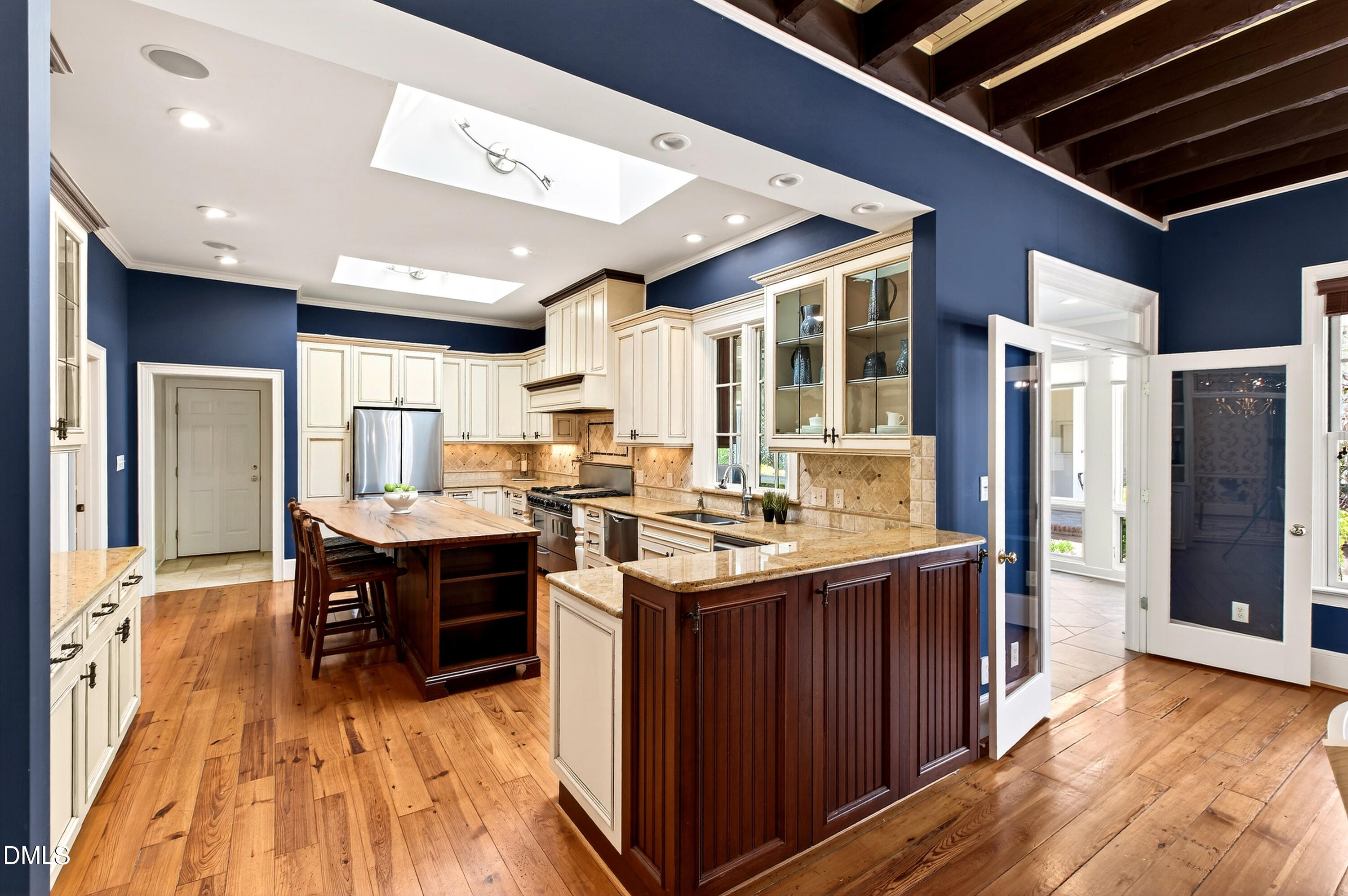 2111 Cook Ridge Court Raleigh, NC 27615 - Photo 25 of 83 a kitchen with stainless steel appliances granite countertop a large stove a sink dishwasher and a refrigerator with wooden floor