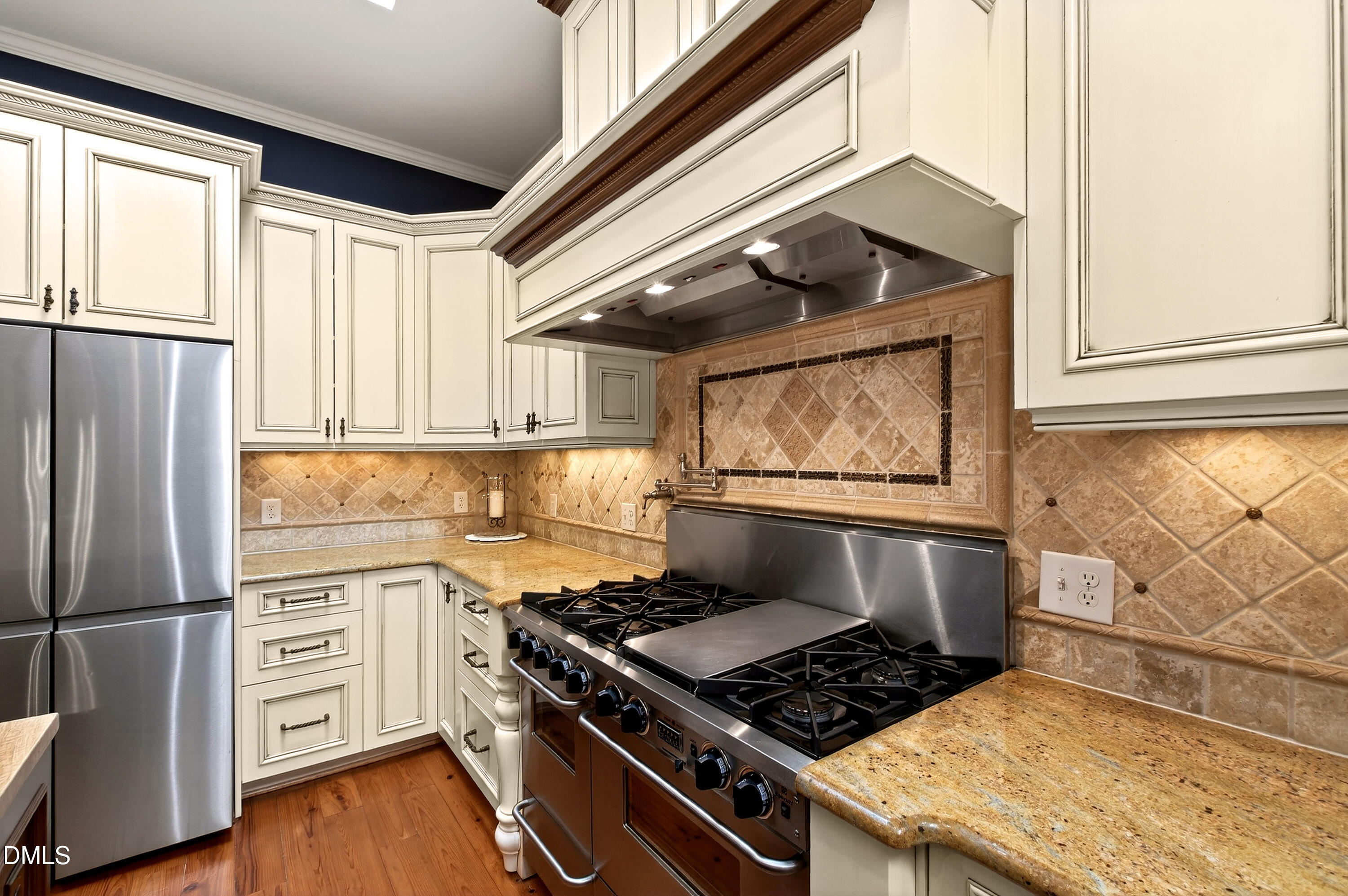 2111 Cook Ridge Court Raleigh, NC 27615 - Photo 27 of 83 a kitchen with stainless steel appliances granite countertop a stove and a refrigerator