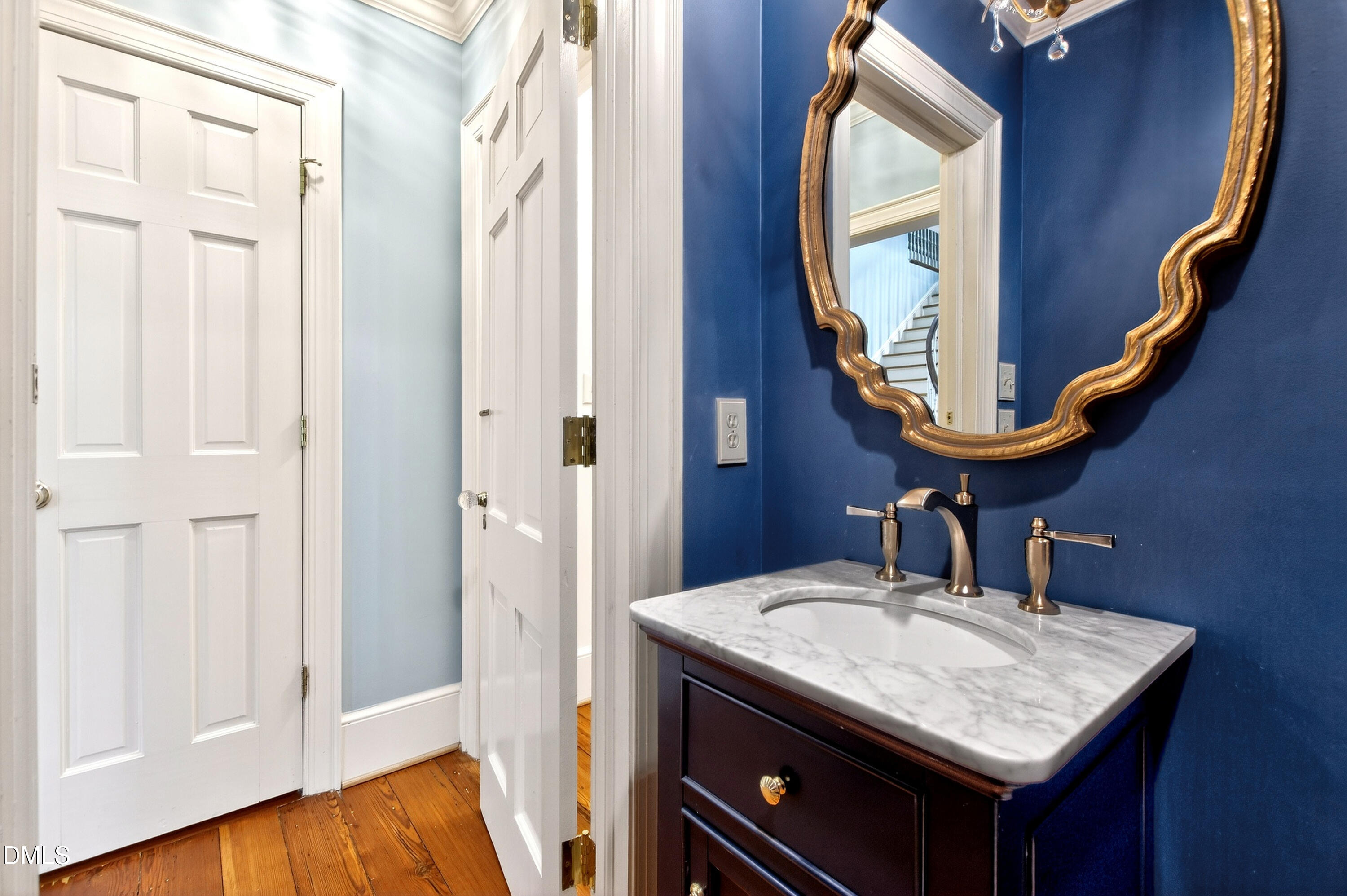 2111 Cook Ridge Court Raleigh, NC 27615 - Photo 32 of 83 a bathroom with a sink a mirror and a vanity