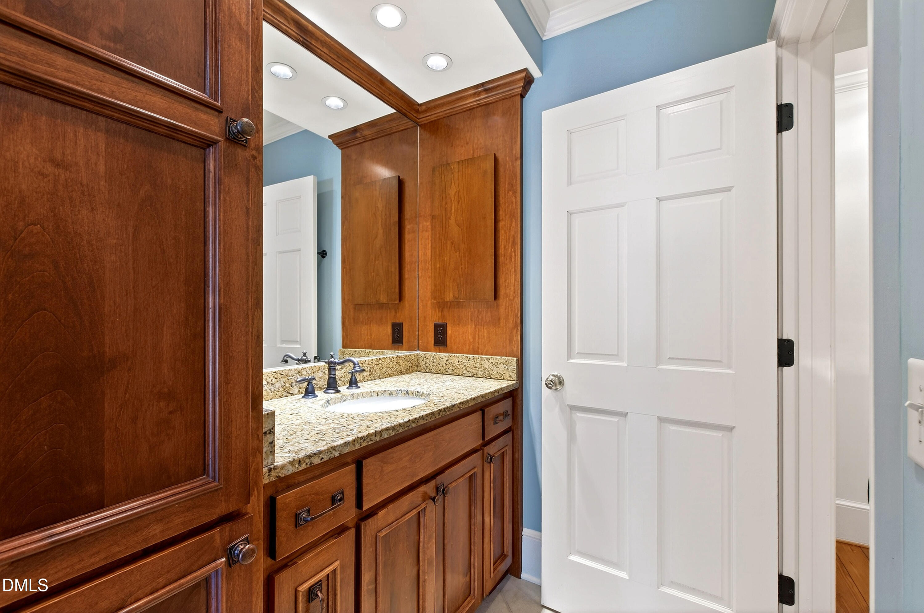 2111 Cook Ridge Court Raleigh, NC 27615 - Photo 35 of 83 a bathroom with a granite countertop sink and a mirror