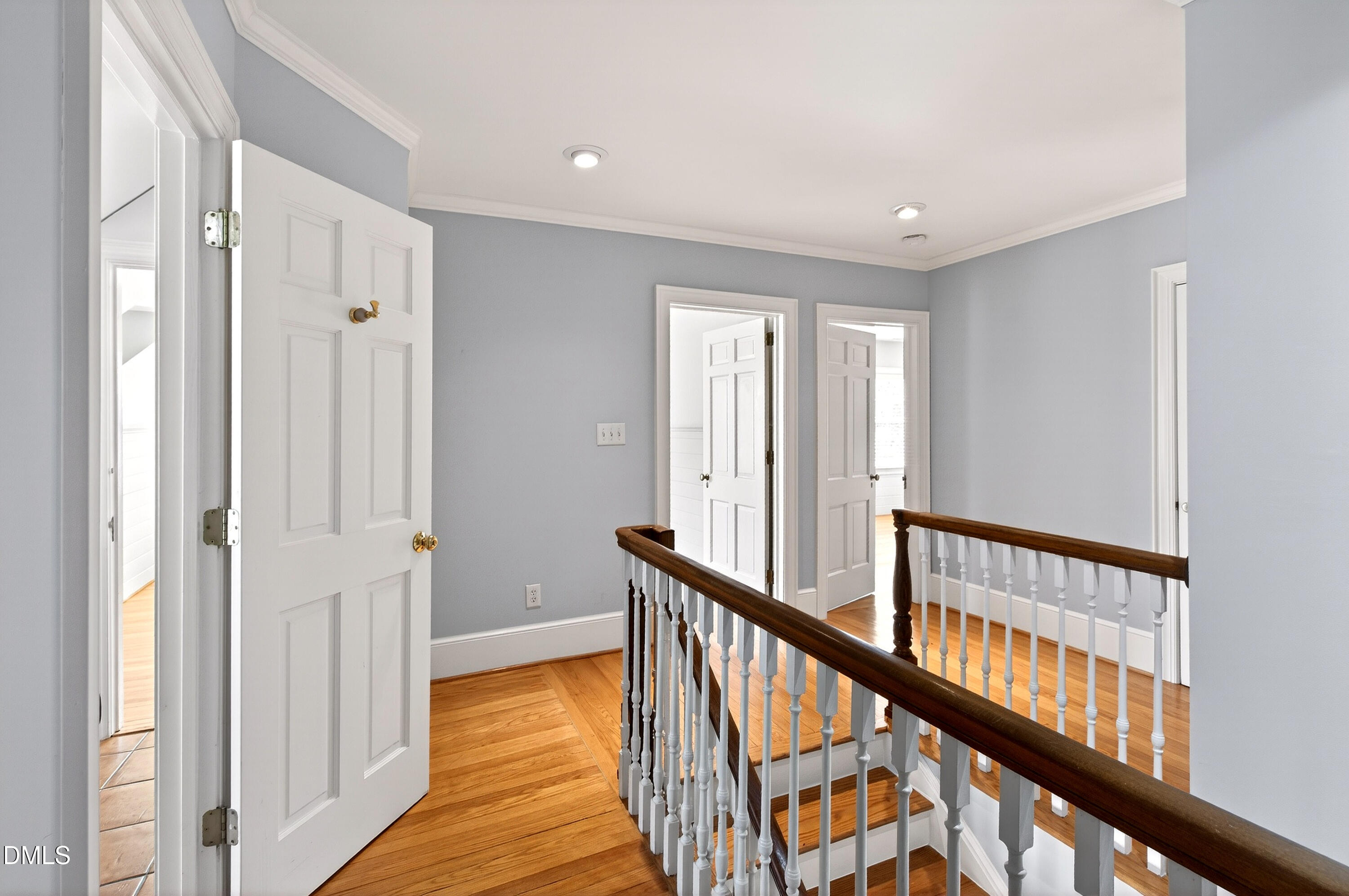 2111 Cook Ridge Court Raleigh, NC 27615 - Photo 51 of 83 a view of a hallway with wooden floor and staircase