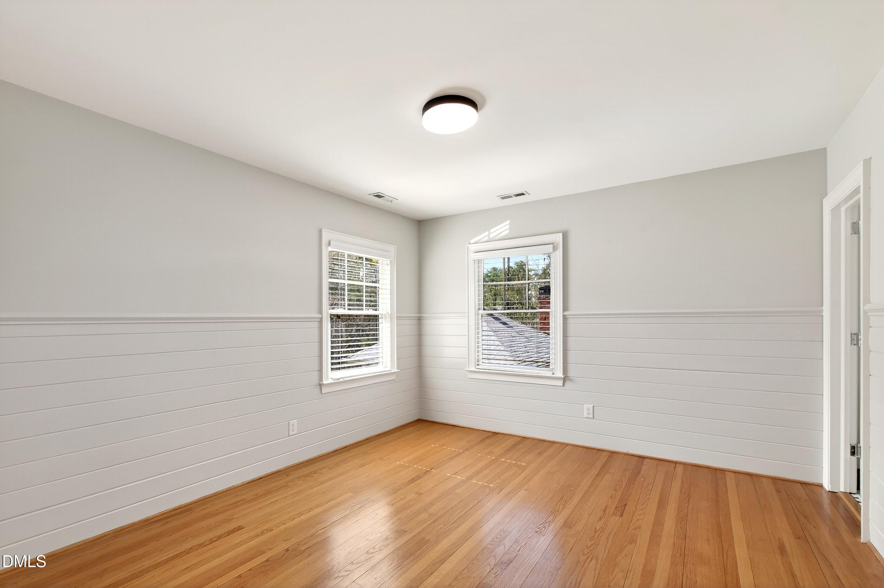2111 Cook Ridge Court Raleigh, NC 27615 - Photo 52 of 83 an empty room with wooden floor and windows