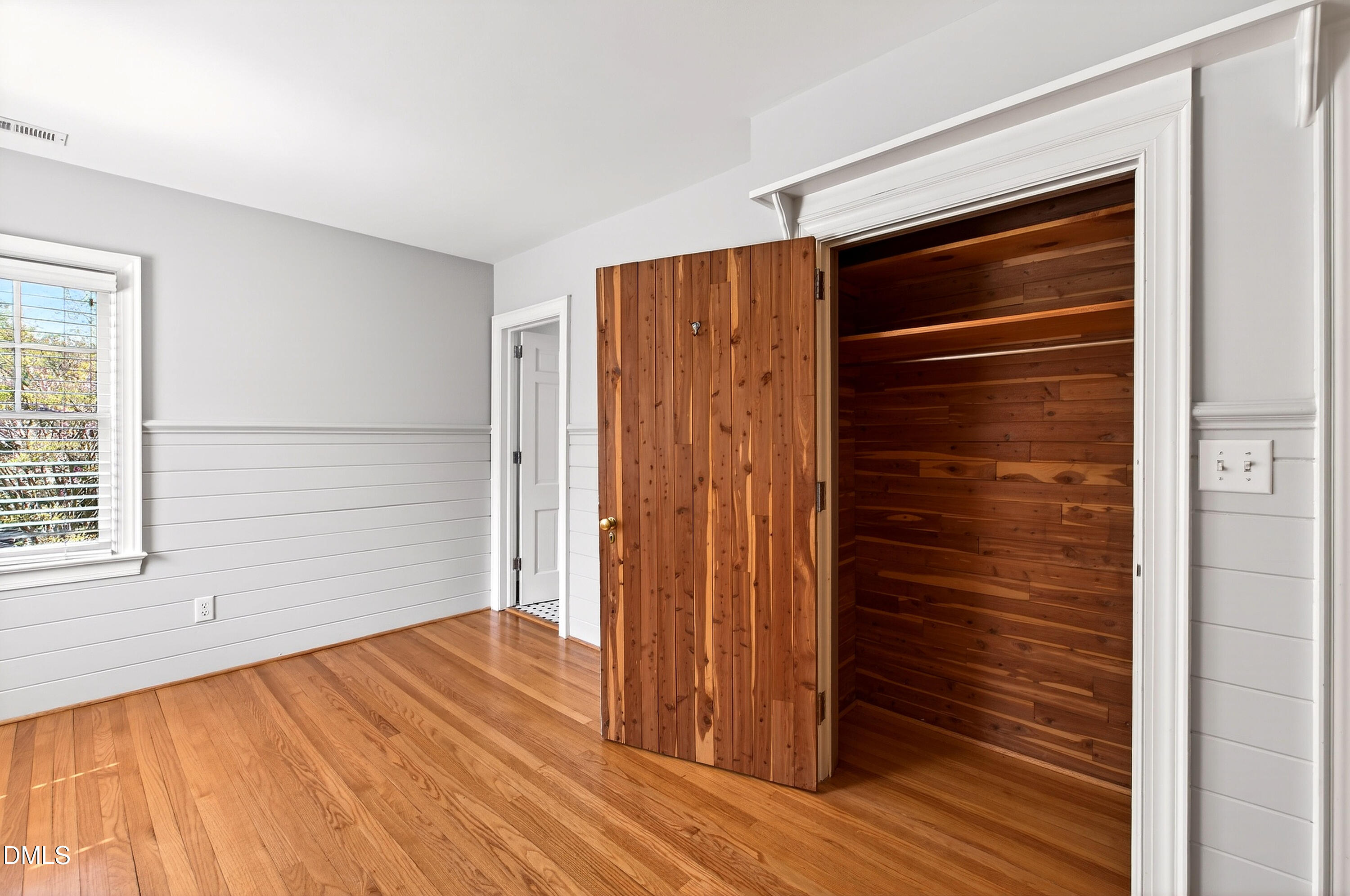 2111 Cook Ridge Court Raleigh, NC 27615 - Photo 54 of 83 a view of an empty room with wooden floor and a window