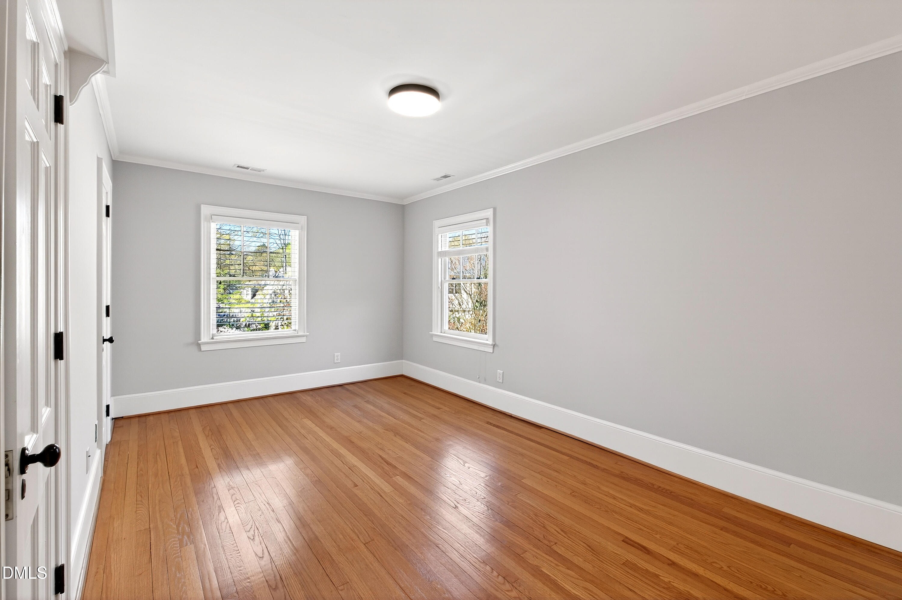 2111 Cook Ridge Court Raleigh, NC 27615 - Photo 57 of 83 an empty room with wooden floor and windows