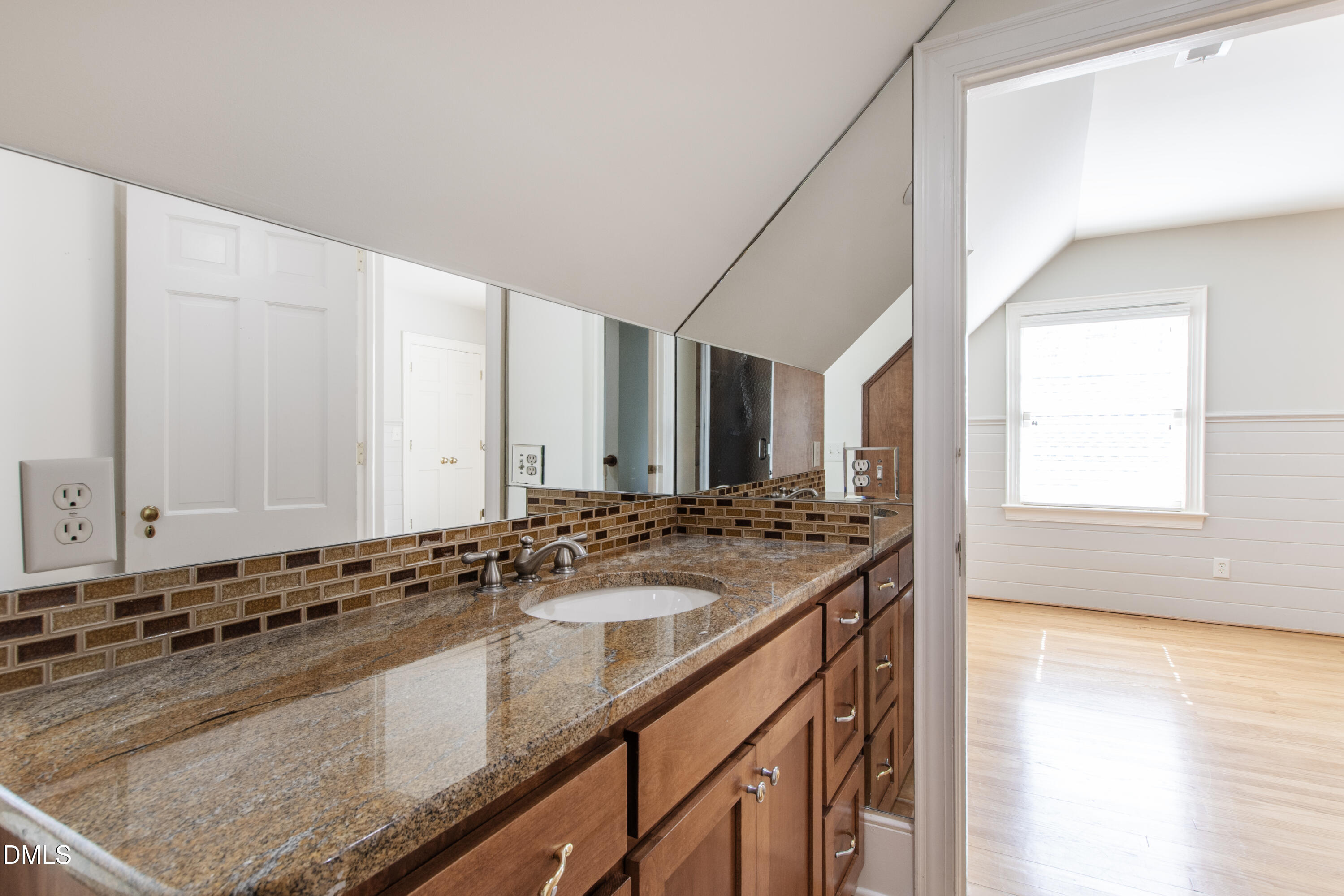 2111 Cook Ridge Court Raleigh, NC 27615 - Photo 61 of 83 a bathroom with a granite countertop sink and a large mirror