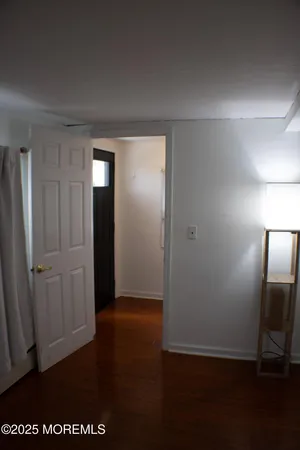 an empty room with wooden floor and closet