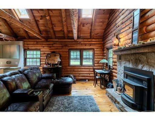 105 Sherbert Road Ashburnham, MA 01430 - Photo 17 of 32 a living room with furniture a fireplace and a flat screen tv