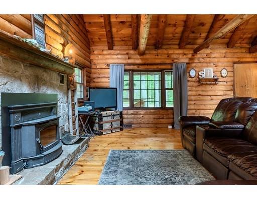 105 Sherbert Road Ashburnham, MA 01430 - Photo 18 of 32 a living room with furniture a flat screen tv and a fireplace